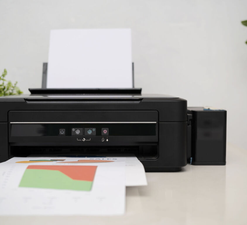 black printer in office with soft-focus